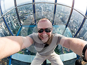 Selfie of man in Skybox of KL Tower in Kuala Lumpur photo