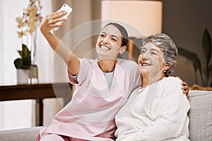 Selfie, nurse and healthcare with a woman carer and senior patient taking a picture in a nursing home together. Phone