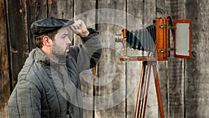 Selfie of old fashioned man on large format camera. Concept - retro photography