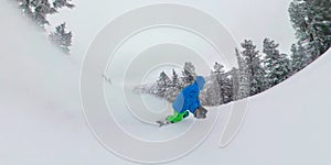 SELFIE: Overcast sky spans above man shredding freshly fallen champagne powder