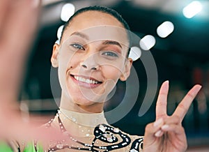 Selfie, peace and olympics with a black woman gymnast in a gym posing for a picture while training alone. Portrait, hand