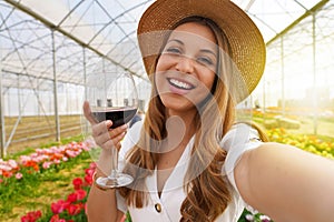 Selfie photo of attractive young woman outdoors holding glass drinking wine on weekend activity