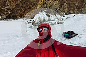 Selfie portrait of a man in a snowy Baikal in hummocks