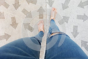 Selfie Shoes with Direction Arrows Choices. Woman Feet and Sandal Standing on Concrete Road Background