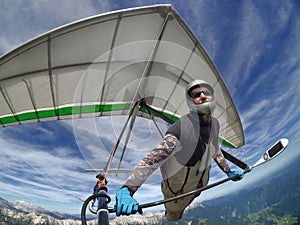 Selfie shot of hang glider pilot soaring the thermal updrafts