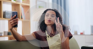 Selfie, smile and woman on sofa in living room with peace sign, silly and goofy face expression. Happy, phone and young