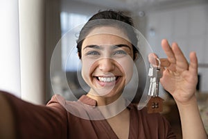 Selfie of smiling Indian woman show keys to new home