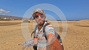 Selfie of a smiling tourist in the dunes of Maspalomas, Gran Canaria,