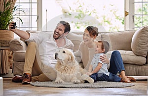 Selfie, social media and happy family in the living room with a dog for internet. Smile, playing and parents, baby and a