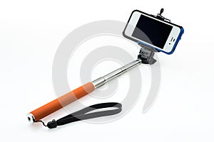 Selfie stick with an adjustable clamp on a white background