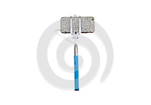 Selfie stick with phone isolated on a white background.