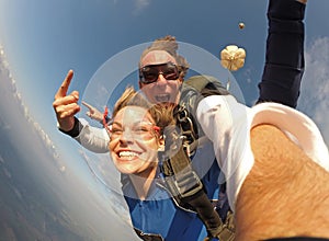 Selfie tandem skydiving with pretty woman