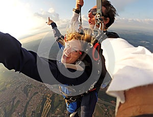 Selfie tandem skydiving with pretty woman