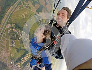 Selfie tandem skydiving with pretty woman