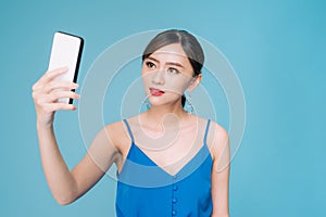 Selfie time. Joyful young women making selfie by her smart phone