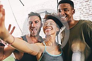 Selfie time with my gym buddies. three sporty young people taking a selfie at the gym.