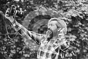 selfie time. vintage camera. capture these memories. SLR camera. hipster man with beard use professional camera