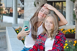 Selfie together. Happy smiling mother and her teenage daughter taking a selfie