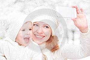 Selfie in winter. happy family mother with daughter and photogr