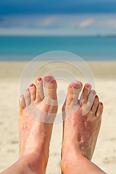 Selfie of woman bare feet, beach and sea