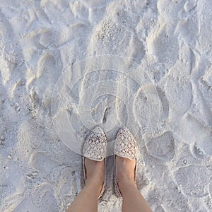 Selfie of woman feet wearing flip flops on a beach