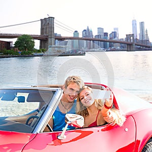 Selfie young couple convertible New York Brooklyn Bridge