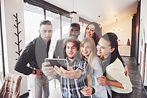 Selfie of young smiling teenagers having fun together. Best friends taking selfie outdoors with backlighting. Happy