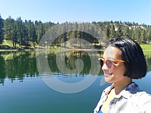 Selfie of young woman at Martin lake near Princeton, British Columbia, Canada