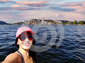 Selfie young woman Okanagan Lake in Kelowna city, British Columbia