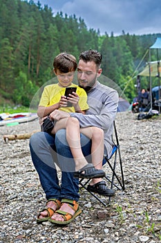 Selfies of father and son in summer on nature