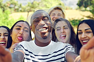 Selfies with my favourites. a group of young friends taking a selfie together outdoors.