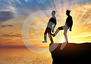Selfish man with a crown is pushing the foot of his business partner into the abyss