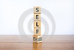 Selfish or selfless symbol. Turned cubes and changed the word `selfish` to `selfless`. Beautiful white background, copy space.