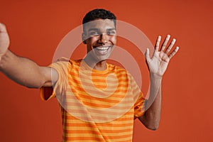 Selfportrait of young handsome smiling happy african man in t-shirt