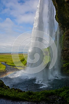 Seljalandsfoss waterfall, Iceland - view from below with rainbow