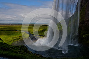 Seljalandsfoss waterfall, Iceland - view from below with rainbow