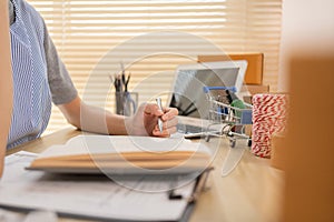 Sell products online, Close-up for hand holding a pen and taking notes in a notebook