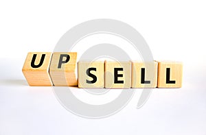 Sell or upsell symbol. Concept word Sell Upsell on wooden cubes. Beautiful white table white background. Business Sell or Upsell