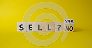 Sell Yes or No symbol. Wooden cubes with words Sell No or Sell Yes. Beautiful yellow background. Business and Sell concept. Copy