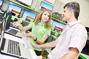 Seller assistant woman help purchaser choosing laptop photo