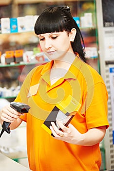 Seller with barcode scanner in shop