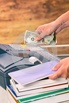 Seller at bookstore using cash register