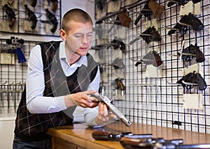 Seller demonstrates a combat winchester in gun store