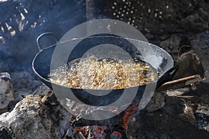 Fried potato an open fire for sale in street market , Zanzibar, Tanzania, Africa