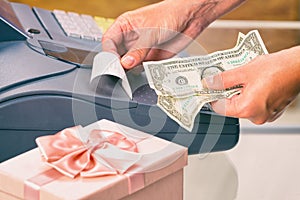 Seller at gift shop using cash register