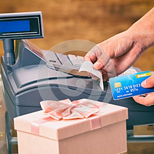 Seller at gift shop using cash register