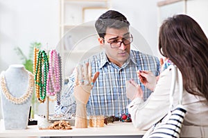 The seller giving price estimate to woman for jewelery