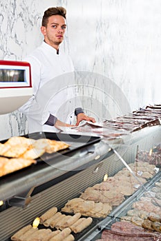 Seller in his grocery shop welcoming customers