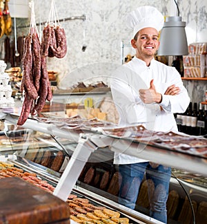 Seller in his grocery shop welcoming customers