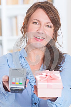 Seller holding payment terminal and goods